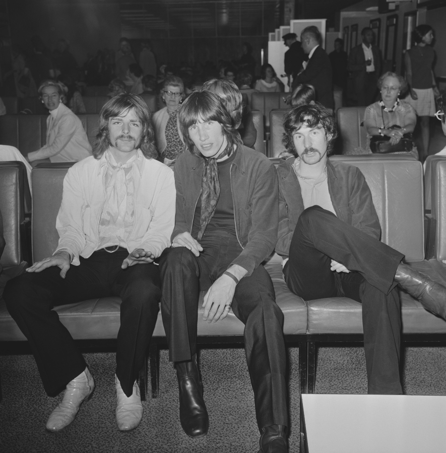 From left, musicians Richard Wright, Roger Waters and Nick Mason of Pink Floyd at Heathrow Airport in London, July 1968.