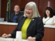 Clark County Councilor Glen Yung, from left, listens to fellow councilor Sue Marshall she speaks to the crowd while joined by councilor Michelle Belkot, right in white, during their swearing in ceremony at the Clark County Public Service Center on Tuesday morning, Jan. 3, 2023.