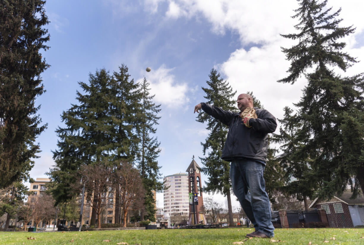 John Scukanec of Washougal plays catch Thursday at Esther Short Park in Vancouver. Scukanec recently wrapped up his first year of playing catch with someone every day.
