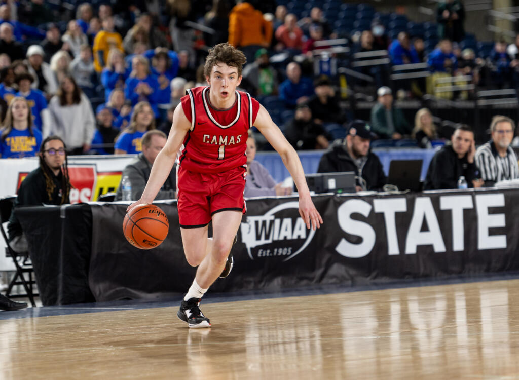 Camas sophomore guard Beckett Currie dribbles during a Class 4A State boys basketball game on Wednesday, March 1, 2023, at the Tacoma Dome.