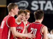 Camas senior forward Josh Dabasinskas celebrates with teammates after victory in a Class 4A State boys basketball game on Wednesday, March 1, 2023, at the Tacoma Dome.