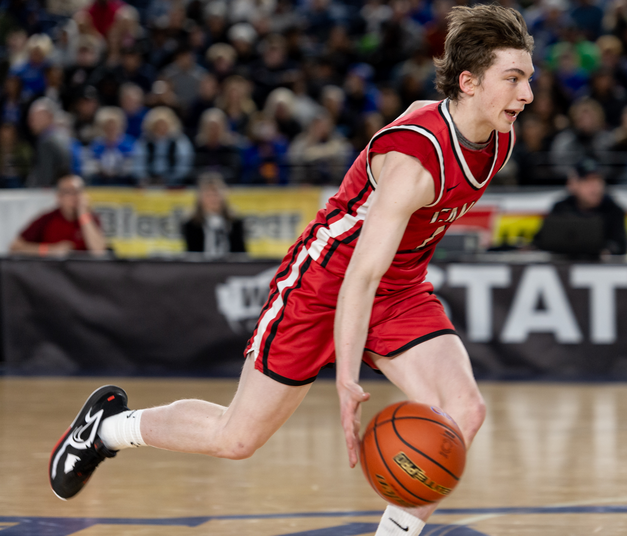 Camas sophomore guard Beckett Currie dribbles up court during a Class 4A State quarterfinal game on Thursday, March 2, 2023, at the Tacoma Dome.