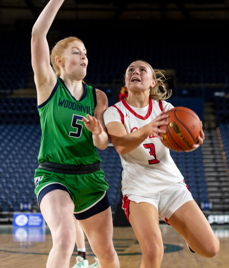 Camas junior guard Riley Sanz looks for space against Woodinville junior Jaecy Eggers during a Class 4A State quarterfinal game on Thursday, March 2, 2023, at the Tacoma Dome.
