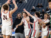 Camas senior guard Matthew Chilian leads the bench celebration during a Class 4A State boys basketball game on Friday, March 3, 2023, at the Tacoma Dome.