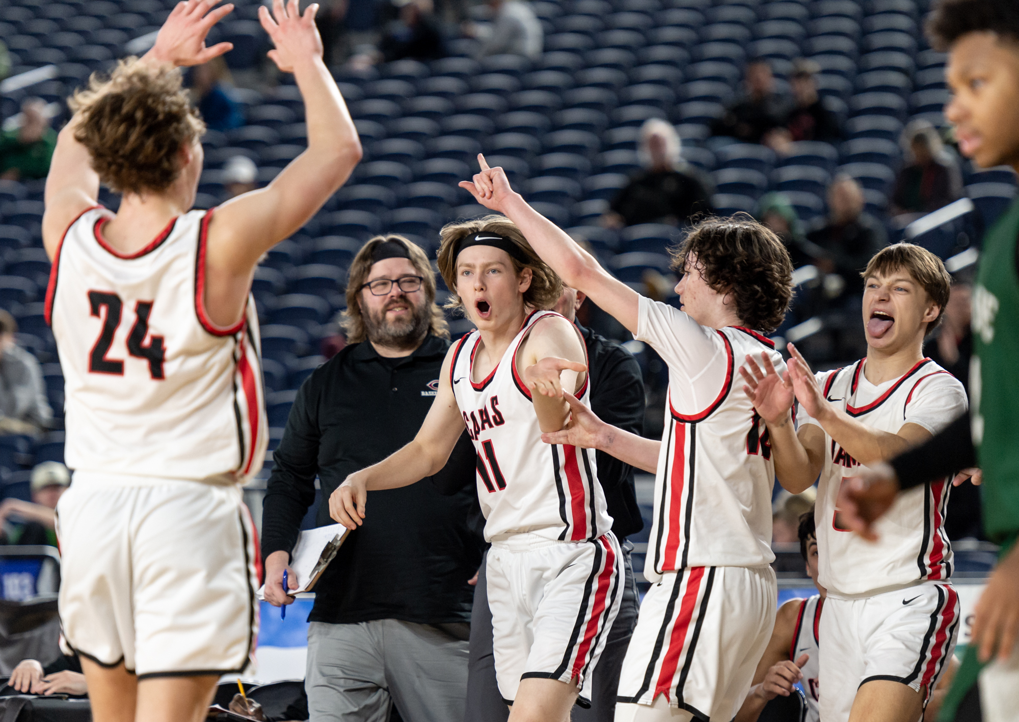 Camas senior guard Matthew Chilian leads the bench celebration during a Class 4A State boys basketball game on Friday, March 3, 2023, at the Tacoma Dome.