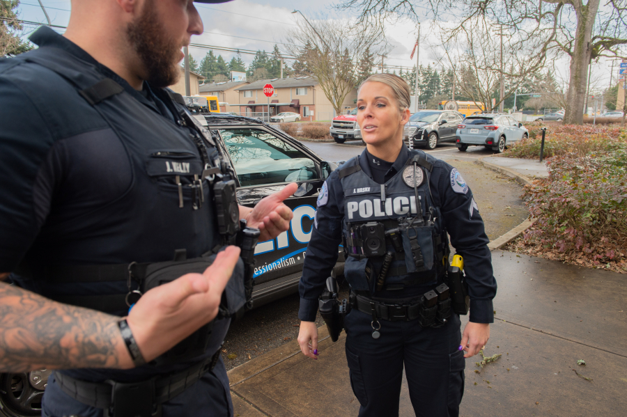 Sgt. James Kelly, left, and Cpl. Jamie Haske talk about the body-worn cameras Vancouver police officers began receiving two weeks ago. Department officials said each officer undergoes training on the agency's policy and hands-on instruction for operating the cameras prior to using the equipment.