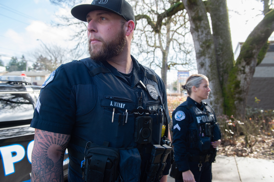 Vancouver police Sgt. James Kelly, left, and Cpl. Jamie Haske stand outside the department's West Precinct wearing Axon body cameras. The officers said the biggest learning curve since receiving the cameras two weeks ago has been remembering to activate the recording before responding to calls.
