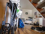 A wheelchair is pictured underneath the stairs as Melissa Worlein, who got coronavirus back in August and has since been struggling with long COVID, takes a break in between chores at her Vancouver home Tuesday afternoon, March 14, 2023.