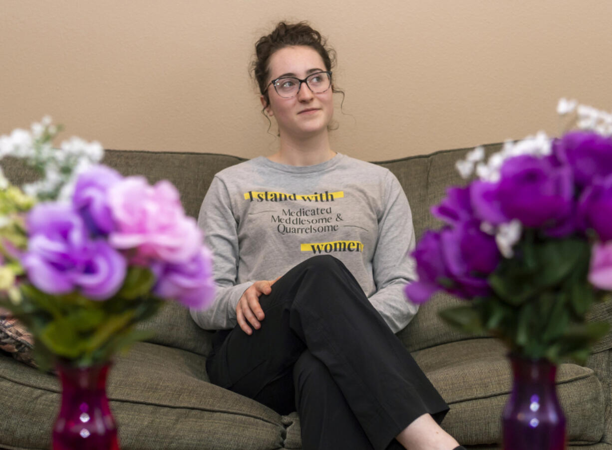 Ally Orr poses for a portrait at Orr's residence in Battle Ground. Her shirt, which she created herself, shares a campaign motto of "I stand with medicated, meddlesome and quarrelsome women." The slogan is a response to a Boise State professor's statement at a National Conservatism Conference in 2021 where he used the three adjectives to describe independent women.