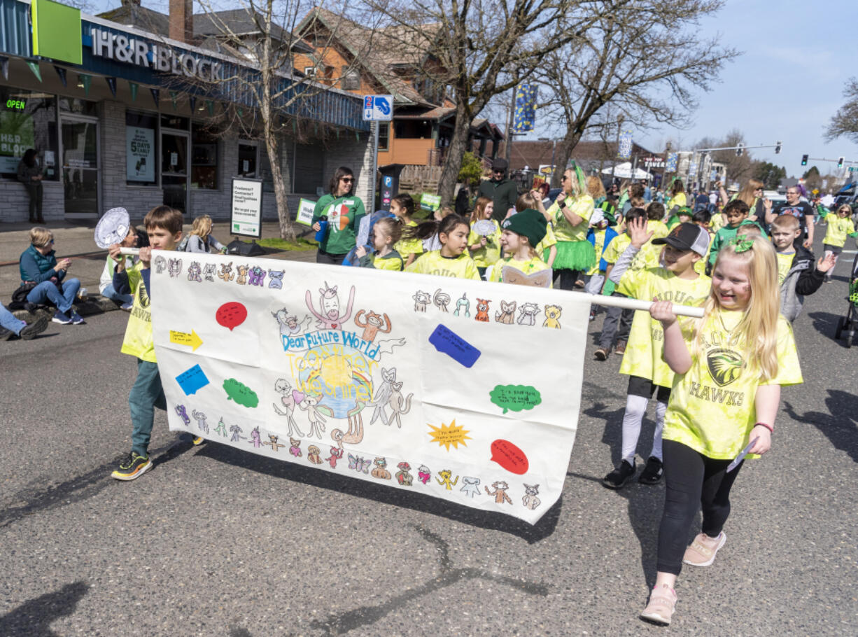 Hough Elementary School students march down Main Street on Friday during the Paddy Hough Parade in Vancouver.