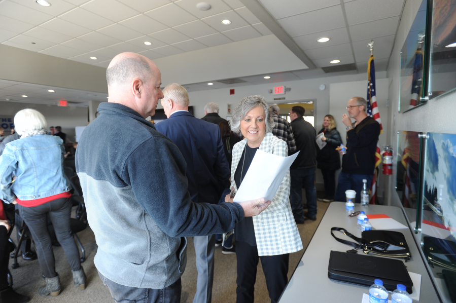 Washington Sen. Lynda Wilson, R-Vancouver, speaks with Vancouver resident Bob Runnells following a 17th District town hall meeting at the Port of Camas-Washougal on March 18.