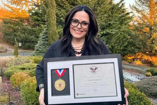 Sandra Sermone poses with the Presidential Award she recently received due to her work trying to cure her son's rare brain disease.
