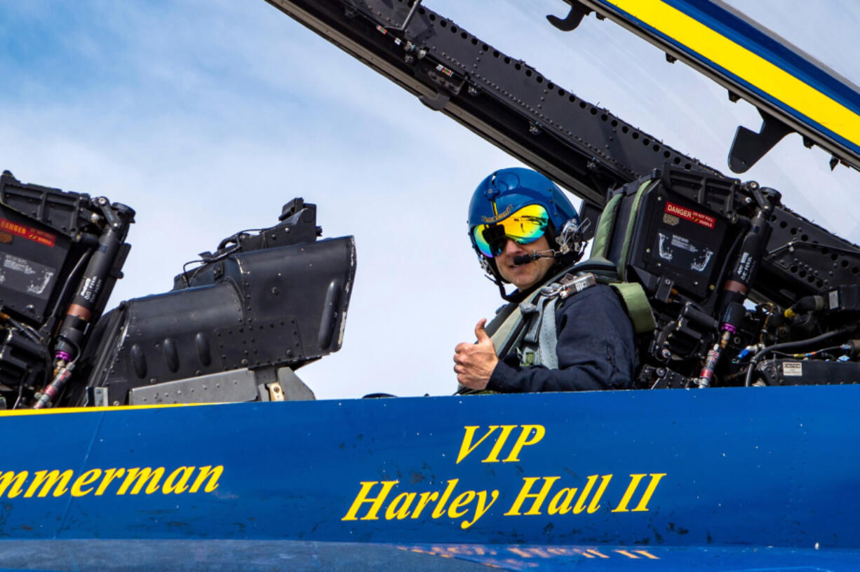 Harley Hall II, son of Vietnam veteran Harley H. Hall, sits in a F/A-18 Super Hornet jet waiting to fly with the Navy's Blue Angels during a flight demonstration on March 17 in Southern California. At top, Hall gets strapped into the Navy Blue Angel jet in preparation for the 45-minute flight at a Navy air show in Southern California. (Photos contributed by U.S.