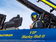 Harley Hall II, son of Vietnam veteran Harley H. Hall, sits in a F/A-18 Super Hornet jet waiting to fly with the Navy's Blue Angels during a flight demonstration on March 17 in Southern California. At top, Hall gets strapped into the Navy Blue Angel jet in preparation for the 45-minute flight at a Navy air show in Southern California. (Photos contributed by U.S.