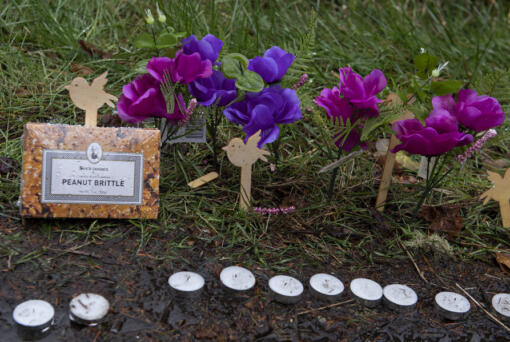 A small memorial is seen Thursday afternoon along Wooding Road in Washougal. Authorities found two bodies, believed to be those of Meshay "Karmen" Melendez and her daughter, Layla Stewart, in a brushy area farther down the road Wednesday.