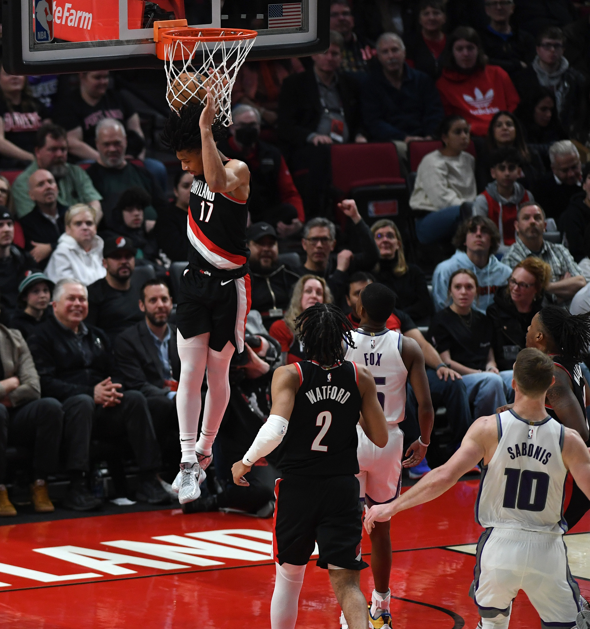 Portland shooting guard Shaedon Sharpe, left, dunks the ball Friday, March 31, 2023, during the Blazers’ 138-114 loss to the Kings at Moda Center.