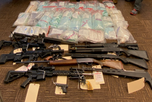 Firearms and suspected drugs, including fentanyl pills, seized in connection with a drug trafficking investigation tied to a white supremacist prison gang. A Ridgefield man was one of 27 people federally indicted in connection with the trafficking ring.
