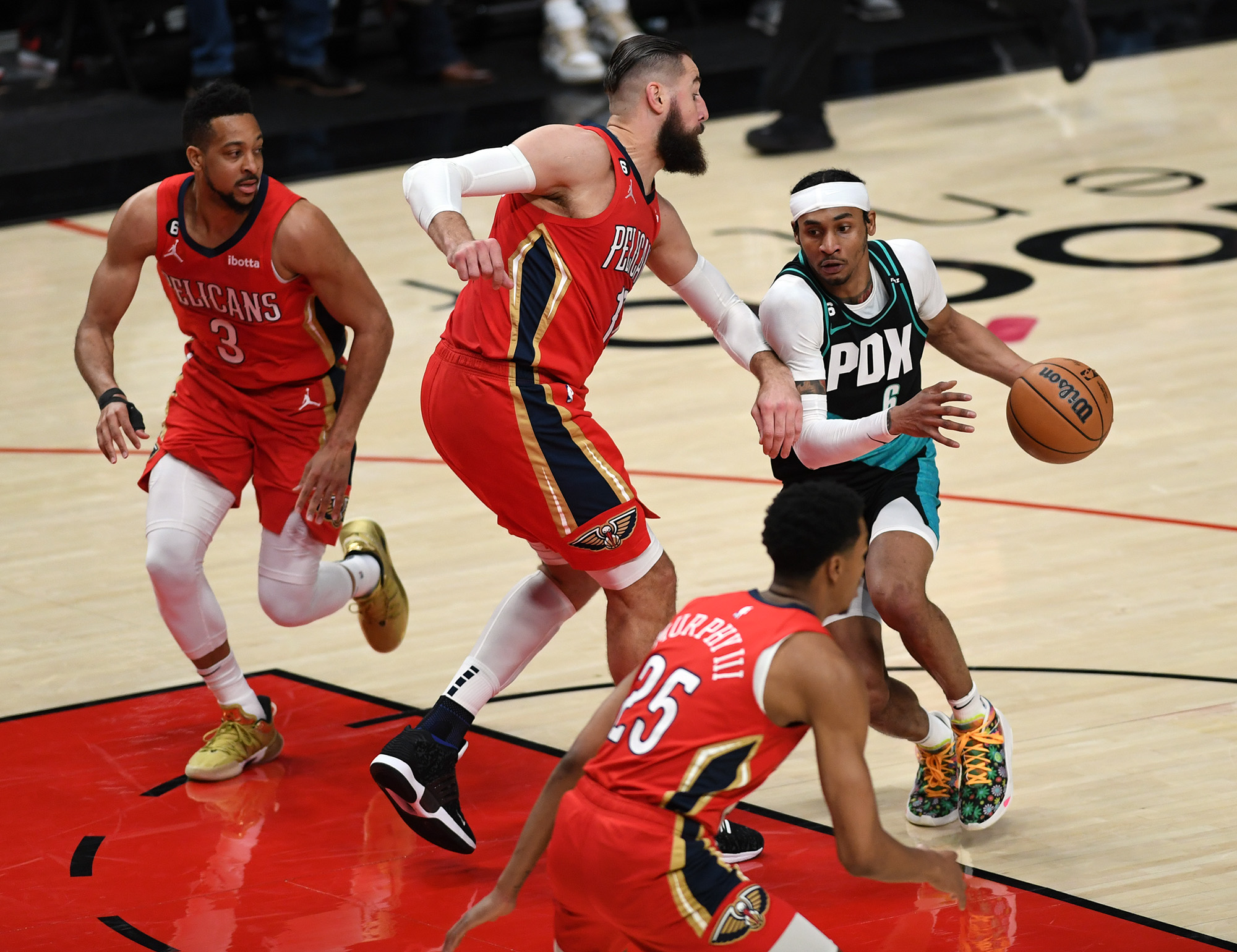 Portland shooting guard Keon Johnson, right, drives to the basket Monday, March 27, 2023, during the Trail Blazers’ 124-90 loss to the Pelicans at Moda Center.