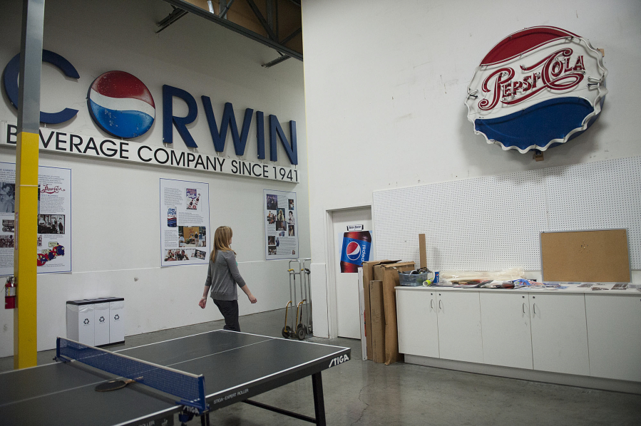Pepsi signs are seen in 2016 lining the interior of Corwin's headquarters as co-owner Heidi Schultz of Corwin Beverage strolls to the sign shop. The business was in the Corwin family for 81 years.
