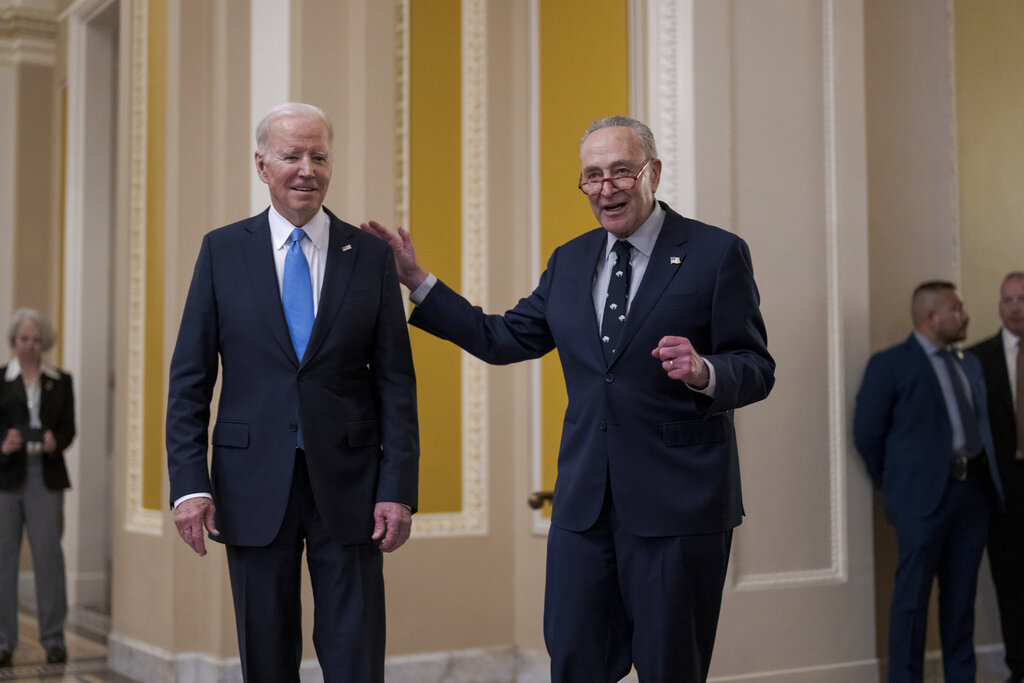 President Joe Biden, left, and Senate Majority Leader Chuck Schumer, D-N.Y., talk to reporters after a lunch with Senate Democrats on his upcoming budget and political agenda, at the Capitol in Washington, Thursday, March 2, 2023. (AP Photo/J.