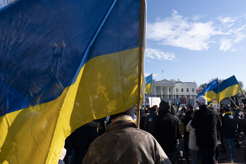 FILE - Activists protest the Russian invasion of Ukraine in Lafayette Park near the White House, Sunday, March 13, 2022, in Washington. The Biden administration is allowing thousands of Ukrainians who fled their homeland when Russia invaded a year ago to stay in the United States longer. The administration announced the decision Monday, March 13, 2023.