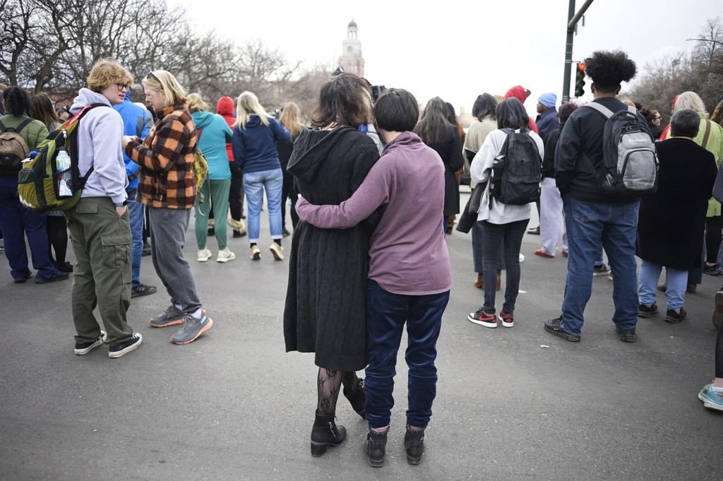 Isabella DeJoseph, 15, center left, is embraced by her mother Alana as they leave East High School after a school shooting, Wednesday, March 22, 2023, in Denver. Two school administrators were shot at the high school Wednesday morning after a handgun was found on a student subjected to daily searches, authorities said.