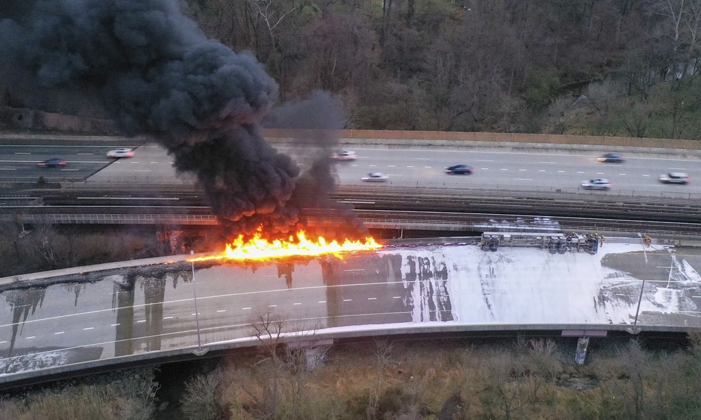 Fuel from an overturned tanker truck burns on northbound Interstate 795 in Pikesville, Md., on Friday morning, March 24, 2023. The driver of the truck was transported to a hospital for treatment, according to state police.