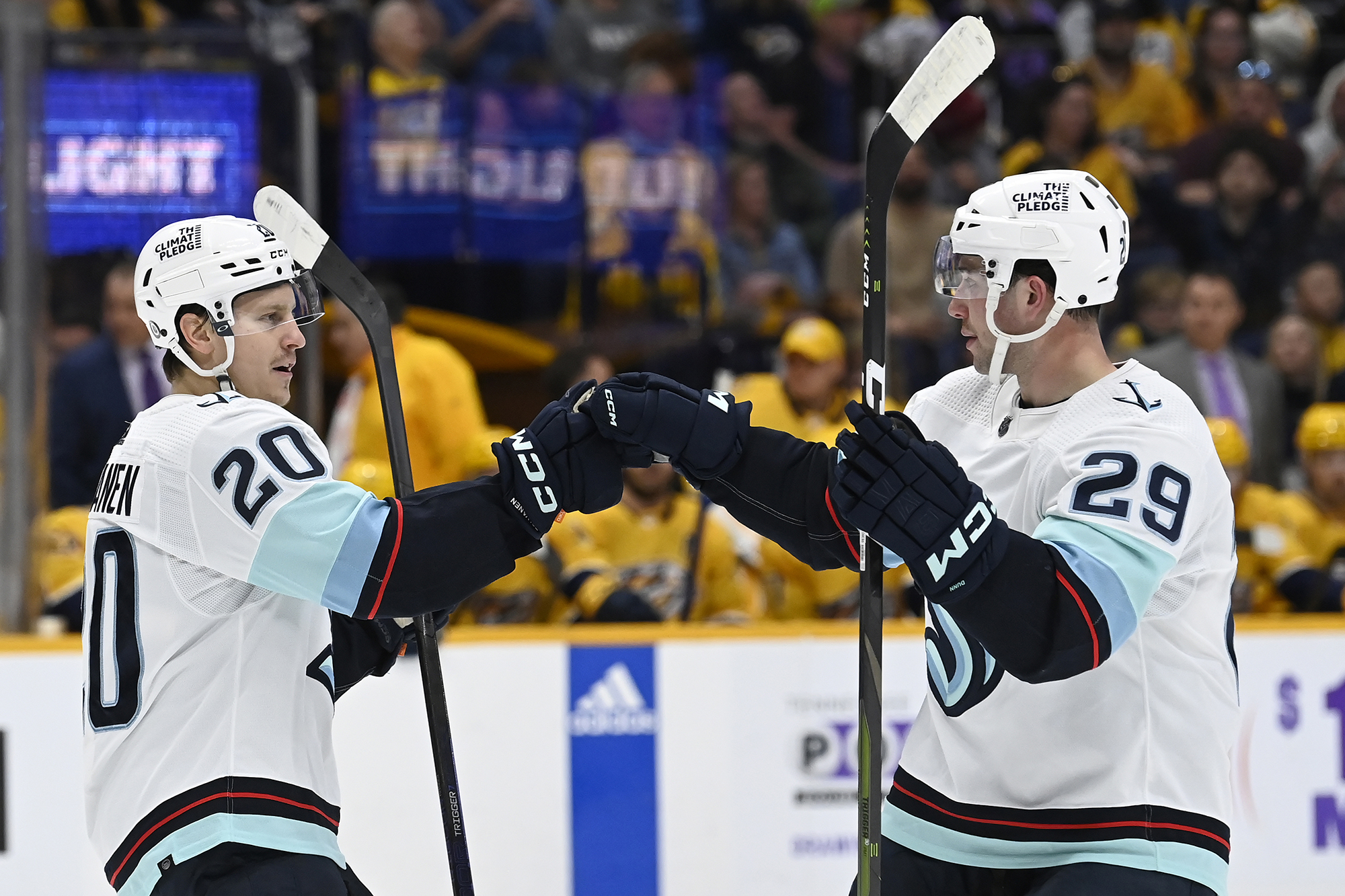 Seattle Kraken right wing Eeli Tolvanen (20) celebrates with defenseman Vince Dunn (29) after scoring a goal against the Nashville Predators during the first period of an NHL hockey game Saturday, March 25, 2023, in Nashville, Tenn.