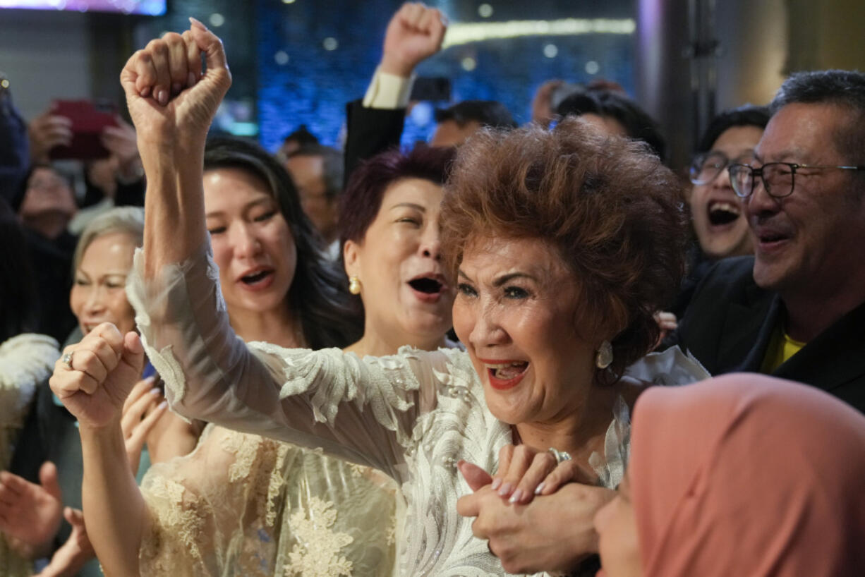 Janet Yeoh, mother of Michelle Yeoh, celebrates after her daughter won in the best actress category during the 95th Academy Awards in Los Angeles, as seen in a live view event at a cinema in Kuala Lumpur, Malaysia, Monday, March 13, 2023.