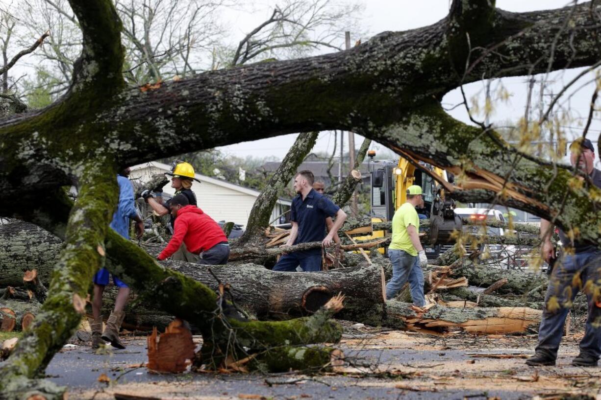 Sherwood, Ark. Police and firefighters get help from volunteers clearing downed trees on Keihl Avenue after storms ripped through the area, Friday, March 31, 2023, in Sherwood, Ark. A monster storm system tore through the South and Midwest on Friday, spawning tornadoes that shredded homes and shopping centers, overturned vehicles and uprooted trees as people raced for shelter.
