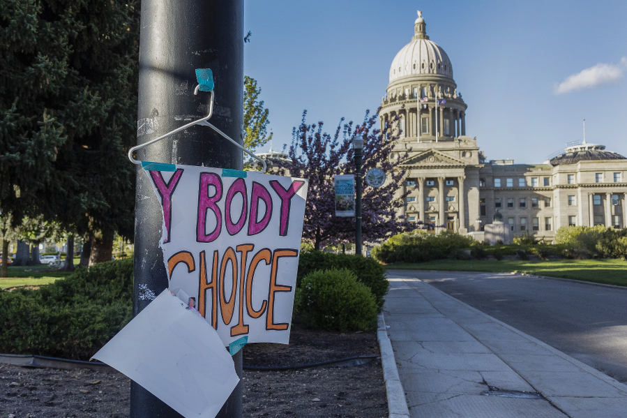 FILE - A sign reading "My body, my choice," is taped to a hanger taped to a streetlight in front of the Idaho state Capitol Building in Boise, Idaho, May 3, 2022. Idaho lawmakers are considering a measure that would bar adults from taking minors to obtain an abortion without their parent's consent. (Sarah A.