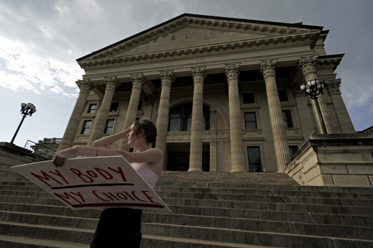FILE - Zoe Schell, from Topeka, Kan., stands on the steps of the Kansas Statehouse during a rally to protest the Supreme Court's ruling on abortion, June 24, 2022, in Topeka. Seven months after a decisive statewide vote affirmed abortion rights in Kansas, the Republican-controlled Legislature's annual session in some ways looks a lot like previous ones, with multiple anti-abortion proposals.