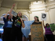 Sarah Bentley, second from left, leads songs at an International Women's Day Sit-In for Abortion Rights in the Texas State Capitol Rotunda, Wednesday, March 8, 2023, in Austin, Texas. Both abortion rights and anti-abortion protesters were present on the rotunda, speaking to curious passers-by, singing songs and occasionally chanting.