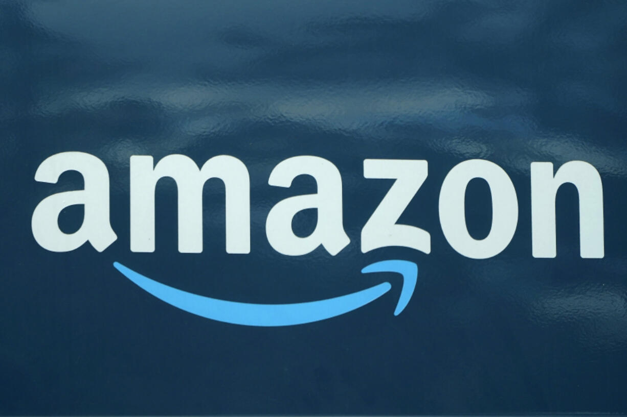FILE - An Amazon logo appears on a delivery van, Oct. 1, 2020, in Boston. Amazon plans to eliminate 9,000 more jobs in the next few weeks, the company's CEO Andy Jassy said in a memo to staff on Monday, March 20, 2023. The job cuts would mark the second largest round of layoffs in the company's history, adding to the 18,000 employees the company said it would lay off in January.