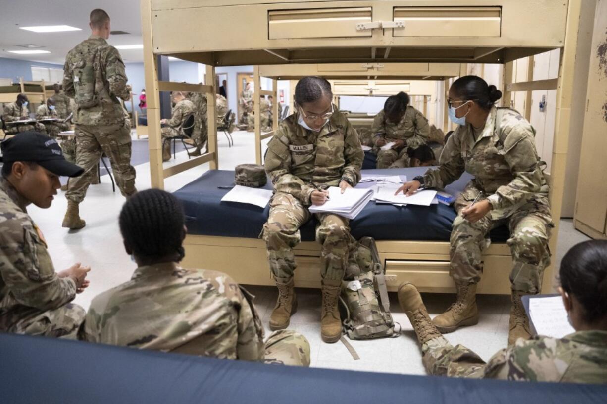 FILE - Students enlisted in the new Army prep course work together in barracks at Fort Jackson in Columbia, S.C., Aug. 26, 2022.