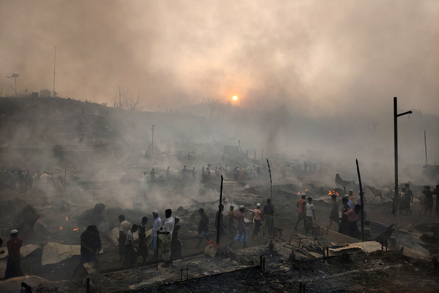 Rohingya refugees try to salvage their belongings after a major fire in their Balukhali camp at Ukhiya in Cox's Bazar district, Bangladesh, Sunday, March 5, 2023. A massive fire raced through a crammed camp of Rohingya refugees in southern Bangladesh on Sunday, leaving thousands homeless, a fire official and the United Nations said.