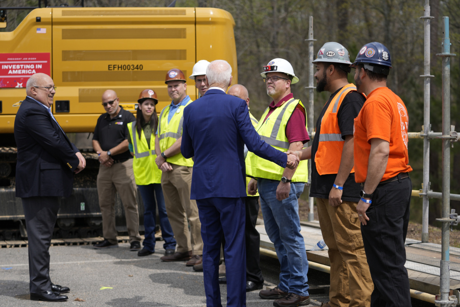 President Joe Biden greets employees as he tours semiconductor manufacturer Wolfspeed Inc., in Durham, N.C., Tuesday, March 28, 2023.