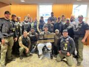 Drew Kennison's regional SWAT team stopped by the hospital to present him with a custom flag, including the team logo.