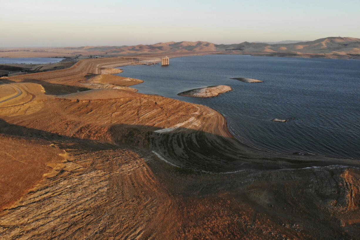 FILE - Water levels are low at San Luis Reservoir, which stores irrigation water for San Joaquin Valley farms, Sept. 14, 2022, in Gustine, Calif. California Gov. Gavin Newsom announced an end to some drought restrictions and calls for water conservation on Friday, March 24, 2023, following a series of winter storms have dramatically improved the state's water supply outlook.