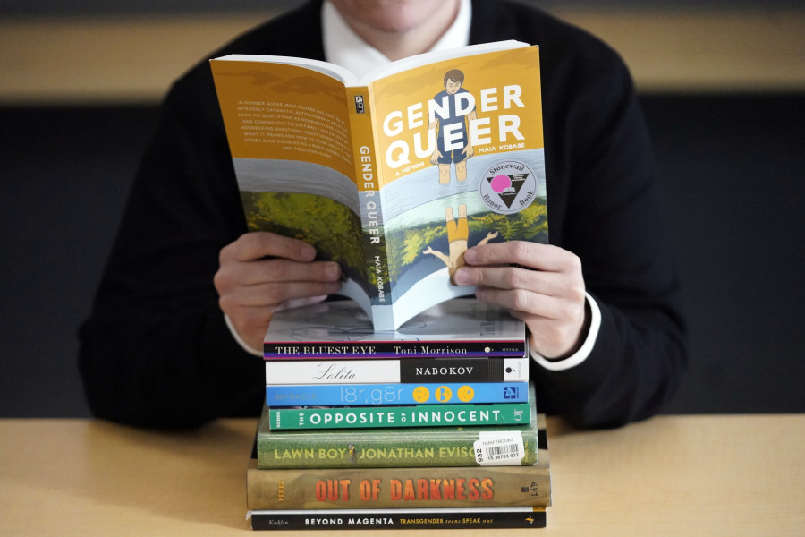FILE - A pile of challenged books appear at the Utah Pride Center in Salt Lake City on Dec. 16, 2021. Attempted book bannings and restrictions at school and public libraries continue to surge, according to a new report from the American Library Association.