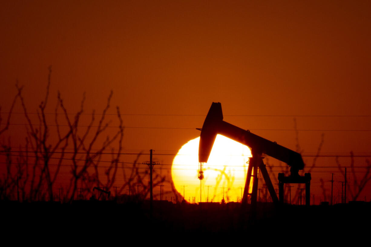 FILE - A pump jack operates as the sun begins to set on the western horizon March 7, 2022, near Pleasant Farms, an unincorporated community in southeastern Ector County, Texas. House Republicans are set to approve a sprawling energy package that counters virtually all of President Joe Biden's agenda to address climate change.