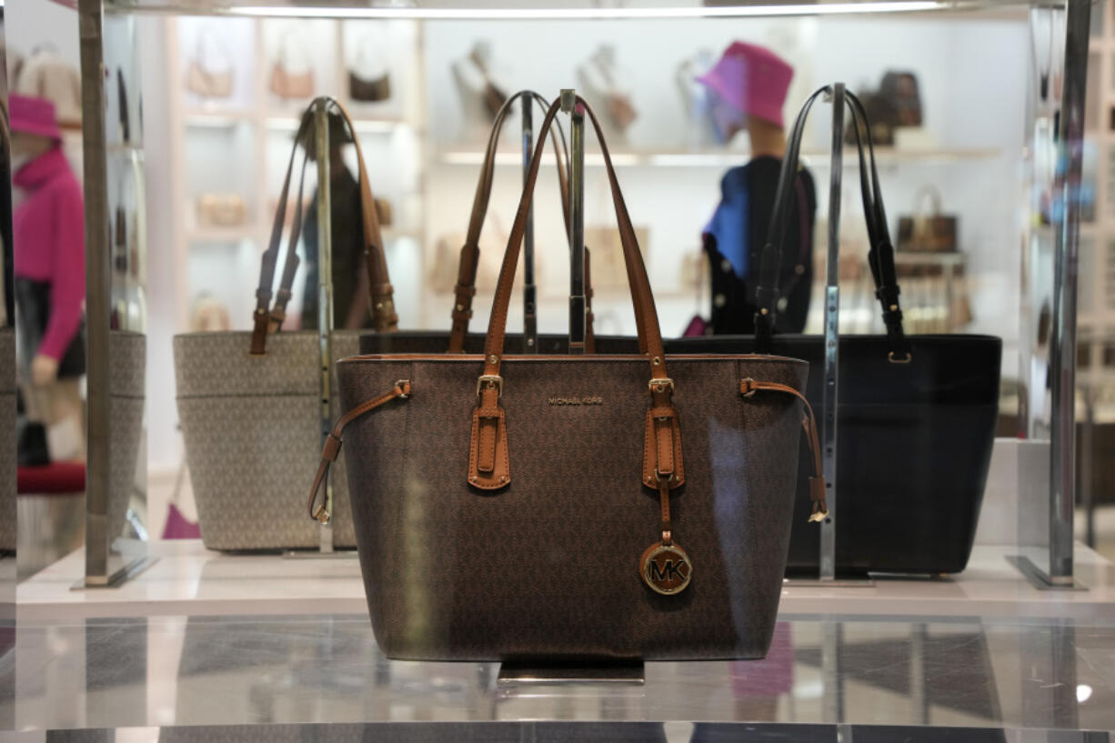 File - Handbags are displayed in the window of a Michael Kors store in Pittsburgh on Monday, Jan. 30, 2023. On Tuesday, the Labor Department reports on U.S. consumer prices for February. (AP Photo/Gene J.