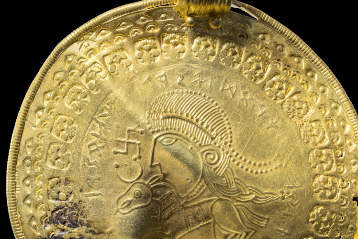 The inscription 'He is Odin's man' is seen in a round half circle over the head of a figure on a golden bracteate unearthed in Vindelev, Denmark in late 2020. Scientists have identified the oldest-known reference to the Norse god Odin on a gold disc unearthed in western Denmark.
