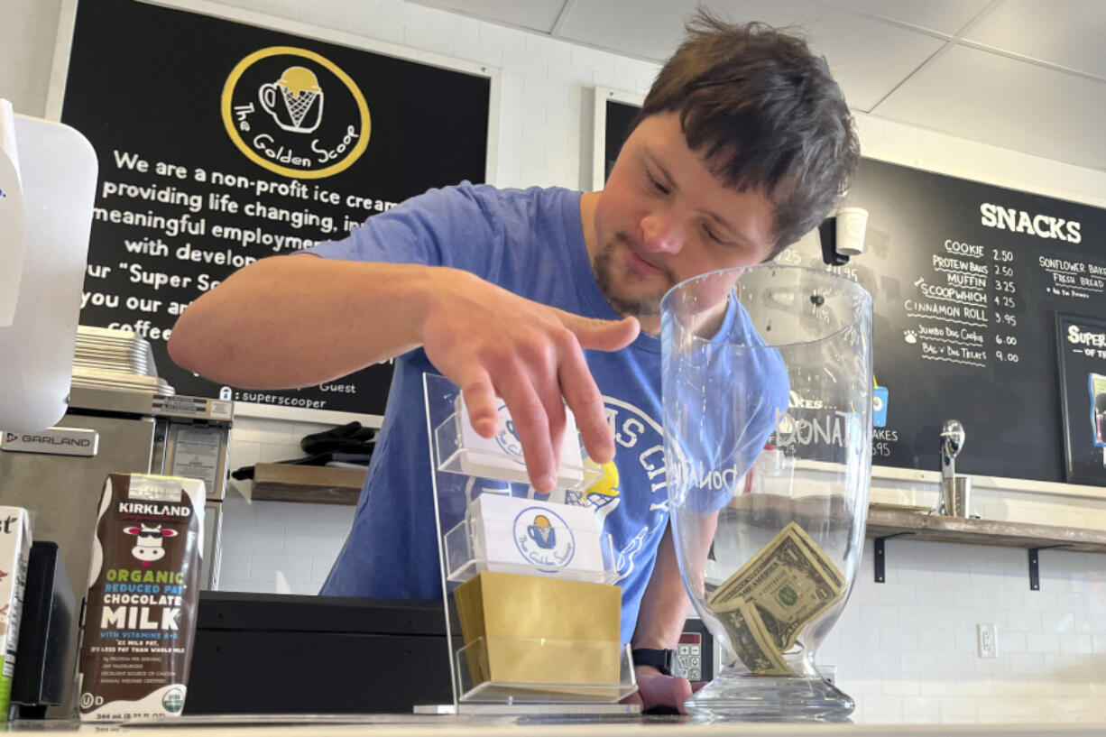 Patrick Chapman, 27, prepares for customers Thursday, March 2, 2023, at The Golden Scoop, an Overland Park, Kan., ice cream and coffee shop that employs workers with developmental disabilities, paying them more than minimum wage. But some disabled workers employed at so-called sheltered workshops are earning far less than minimum wage, an issue that has captured the attention of lawmakers in the state. Disability rights advocates say the practice is discriminatory and more than a dozen states have banned such wages.