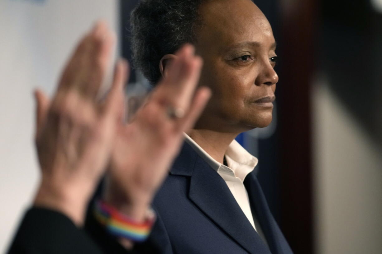 Chicago Mayor Lori Lightfoot pauses during her concession speech as her spouse Amy Eshleman applauds during an election night party for the mayoral election Tuesday, Feb. 28, 2023, in Chicago.