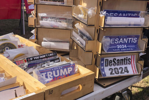 FILE - Bumper stickers supporting Florida Gov. Ron DeSantis on sale at former President Donald Trump's rally in Conroe, Texas, Jan. 29, 2022. DeSantis, a leading Republican presidential prospect, has emerged as a potent force in national politics while eschewing the personal connections, intimate moments and unscripted questions that have long fueled successful White House bids.