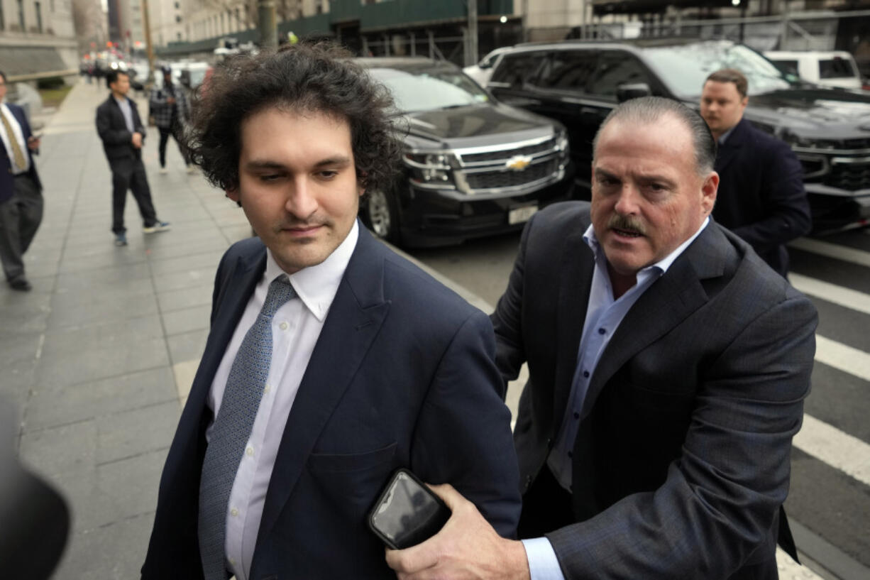 FILE - FTX founder Sam Bankman-Fried, left, arrives at Manhattan federal court on Feb. 16, 2023, in New York. In a proposal submitted Friday, March 3, 2023, prosecutors and attorneys for Bankman-Fried are requesting the disgraced cryptocurrency entrepreneur be allowed a flip-phone or another device that's not a smartphone while on bail.