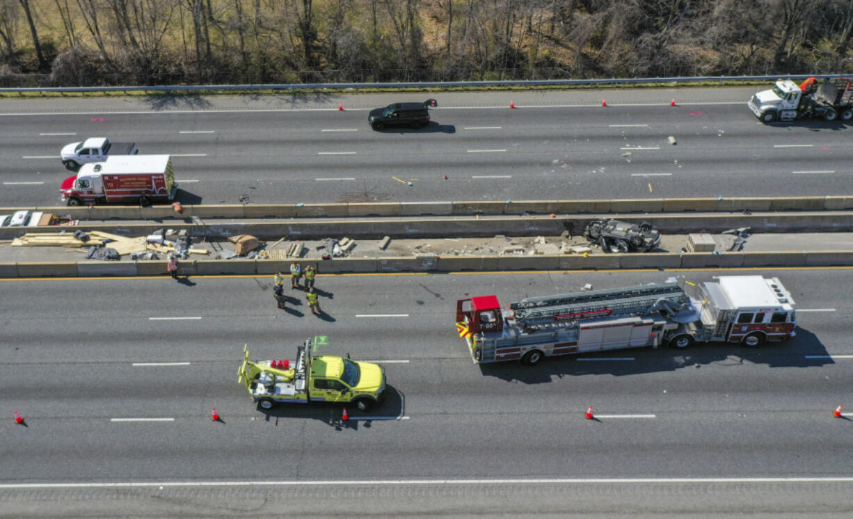 Emergency personnel work at the scene of fatal crash along Interstate 695 near Woodlawn, Md., Wednesday, March 22, 2023. At least six people were dead after a crash that closed the Baltimore Beltway in both directions Wednesday, snarling traffic along the west side of the highway that encircles the city, Maryland State Police said.