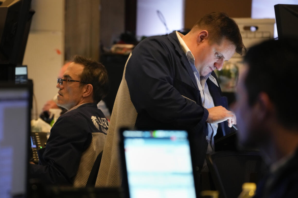 Traders work on the floor at the New York Stock Exchange in New York, Wednesday, March 22, 2023.
