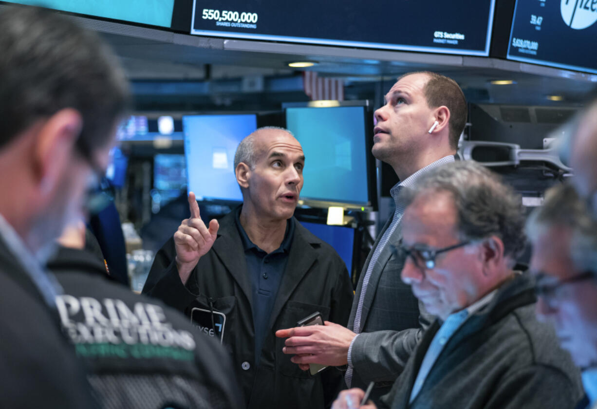 Traders work on the floor at the New York Stock Exchange in New York, Monday, March 13, 2023.
